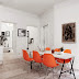 A monochrome apartment with a touch of orange