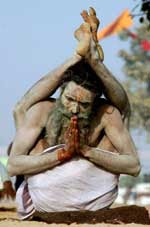 Photo of a yogi with his legs up behind his shoulders