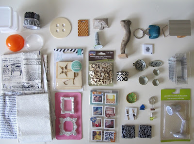 Selection of dolls' house miniatures and craft items laid out on a tabletop