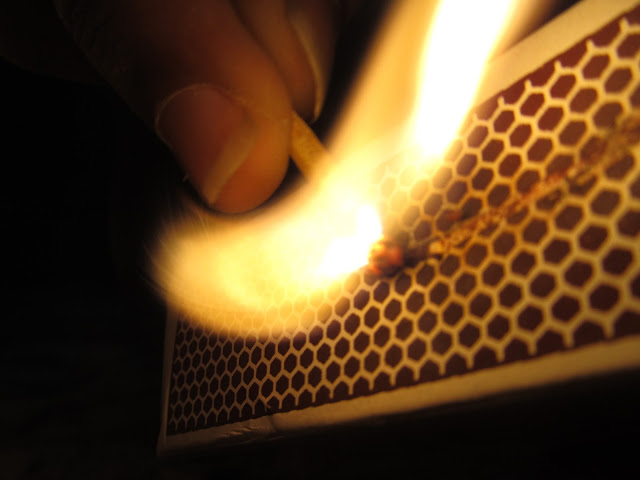 Igniting the fire - matchstick against a matchbox- starting fire