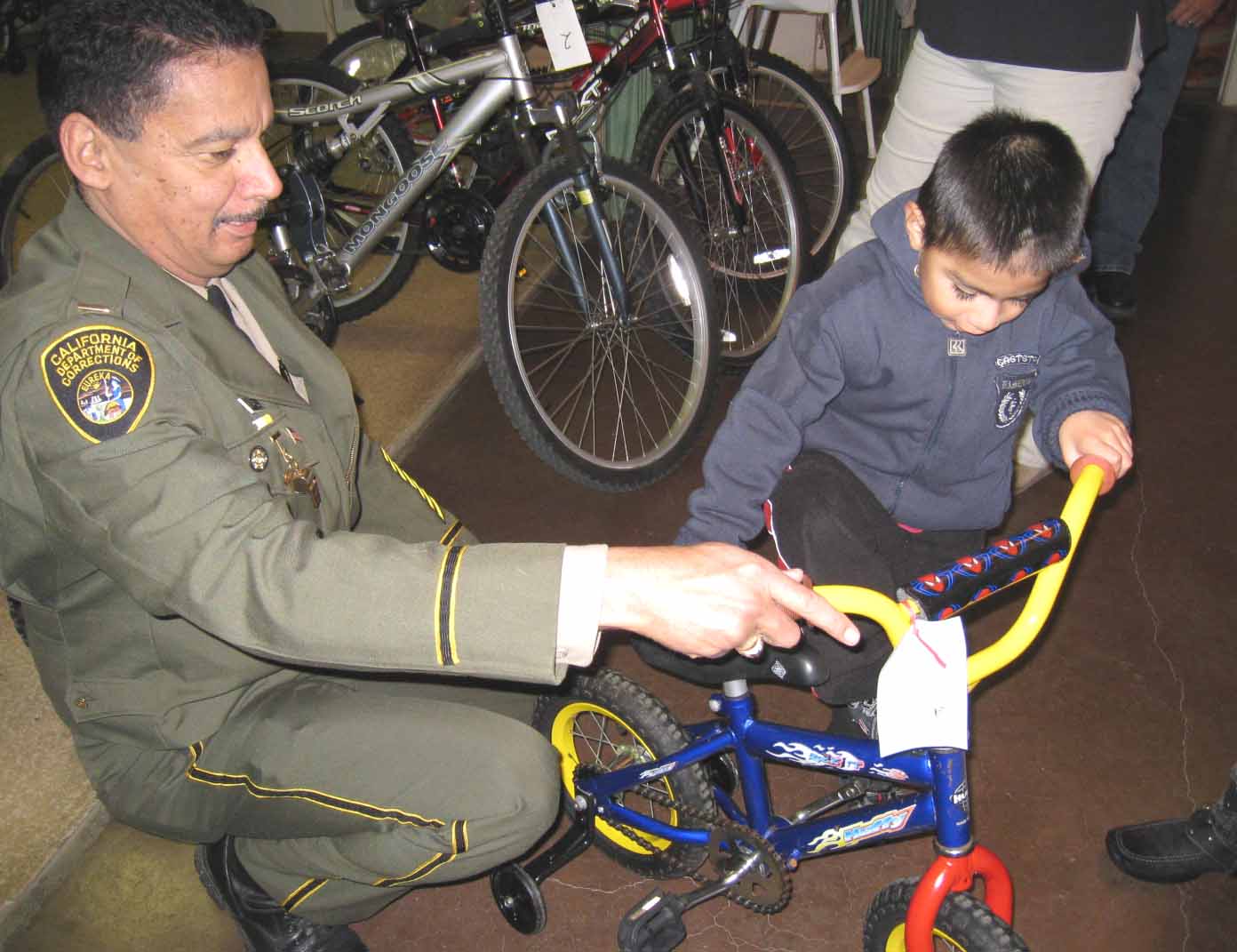 SATF+Lieutenant+assists+a+child+with+a+bike.jpg
