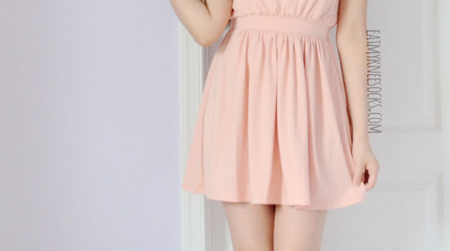 WalkTrendy - Pink Halter Dress Modeled Close-up of the hem on the pastel pink WalkTrendy chain halterneck dress.