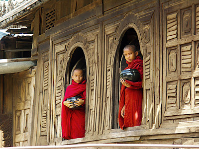 Buddhist novices with begging bowls in the monastery