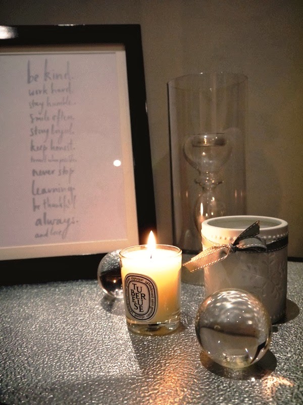 Diptyque candle, crystal balls, framed quotes