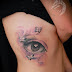 tattoo feminina olho em 3d na costela