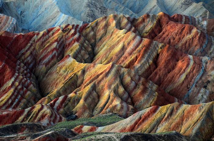 These incredible landscapes look as if they have been painted in the sweeping pastel brush strokes of an impressionistic artwork. But in fact these remarkable pictures show the actual scenery of Danxia Landform at Nantaizi village of Nijiaying town, in Linzhe county of Zhangye, Gansu province of China. Formed of layers of reddish sandstone, the terrain has over time been eroded into a series of mountains surrounded by curvaceous cliffs and unusual rock formations.