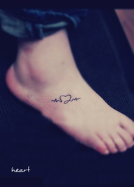 A CURLY HEART TATTOO ON FOOT