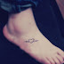 A CURLY HEART TATTOO ON FOOT