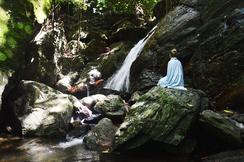 girl wrapped in sheet waking up at tropical rainforest waterfall girl wrapped in sheet waking up at tropical rainforest waterfall