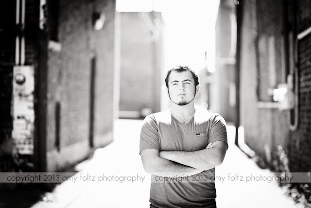 black and white photo of senior boy in alley - Terre Haute Clinton Indiana photographer