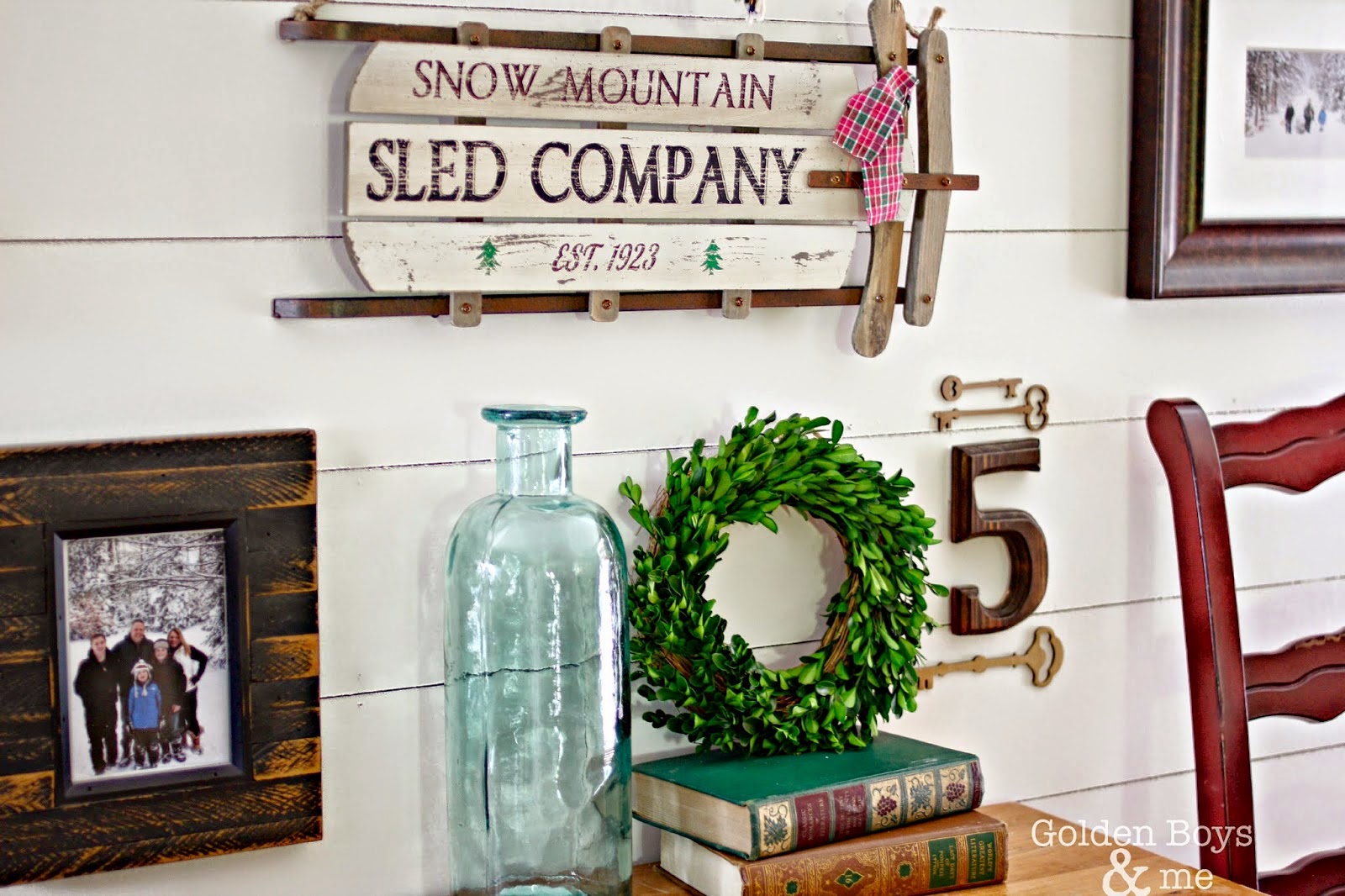 Winter theme planked gallery wall in rustic Christmas family room-www.goldenboysandme.com