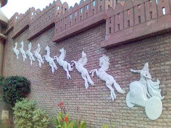 16 HOURSES WITH 2 CHERATS  WALL MURAL  IN FIBER GLASS ON THE OPPOSITE WALL IN BAHRIA TOWN LAHORE