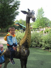 Alexandre on a giraffe at Granby Zoo