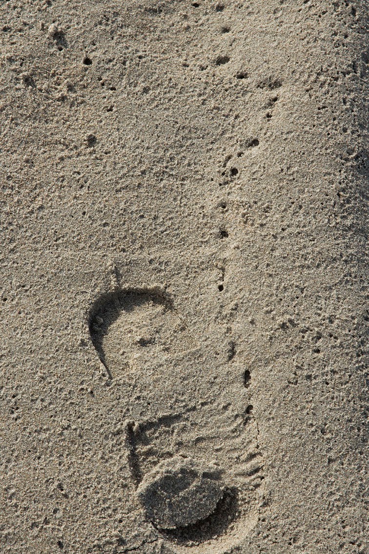 child's footstep in sand