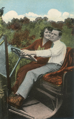 vintage postcard of cuddling couple in a car