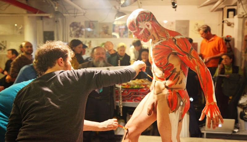 File:Man receiving body paint   Wikimedia Commons