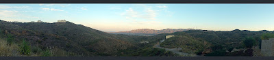 A panorama taking in the view from the front of the house at dusk.