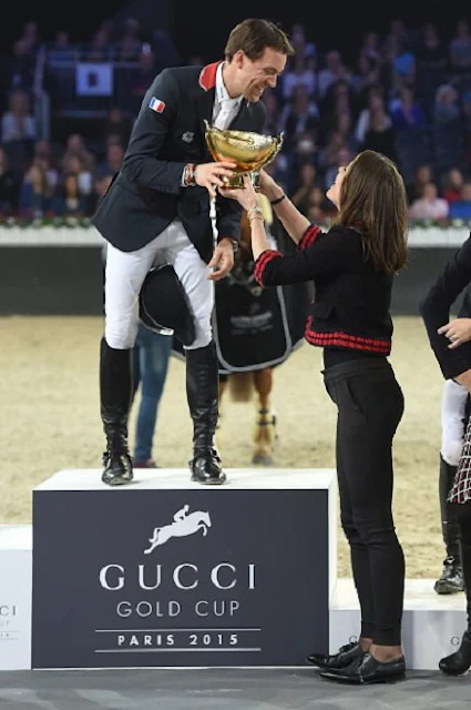 Charlotte Casiraghi  present the trophies to the GUCCI Gold Cup (CSI5) podium, winner Simon Delestre of France, second Patrice Delaveau of France  and third Maikel van der Vleuten of The Netherlands prior to the 'Style and Competition' show jumping charity event benefitting 'AMADE' on day three of the Longines Paris Masters 2015 held at the Paris-Nord Villepinte Exhibition Center