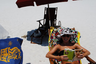 Caitlin Houston reading book in lounge chair at Beach at Luxury Destin Florida Penthouse Condo