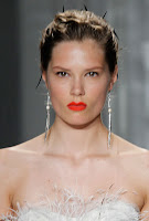 Jason Wu's models rocked an edgy-yet-sophisticated pairing of shocking orange-red lips and twisted updos spiked with black feathers, Fit for daring, fashion-forward brides only Twisted Updos Spiked with Black Feathers Hairstyle