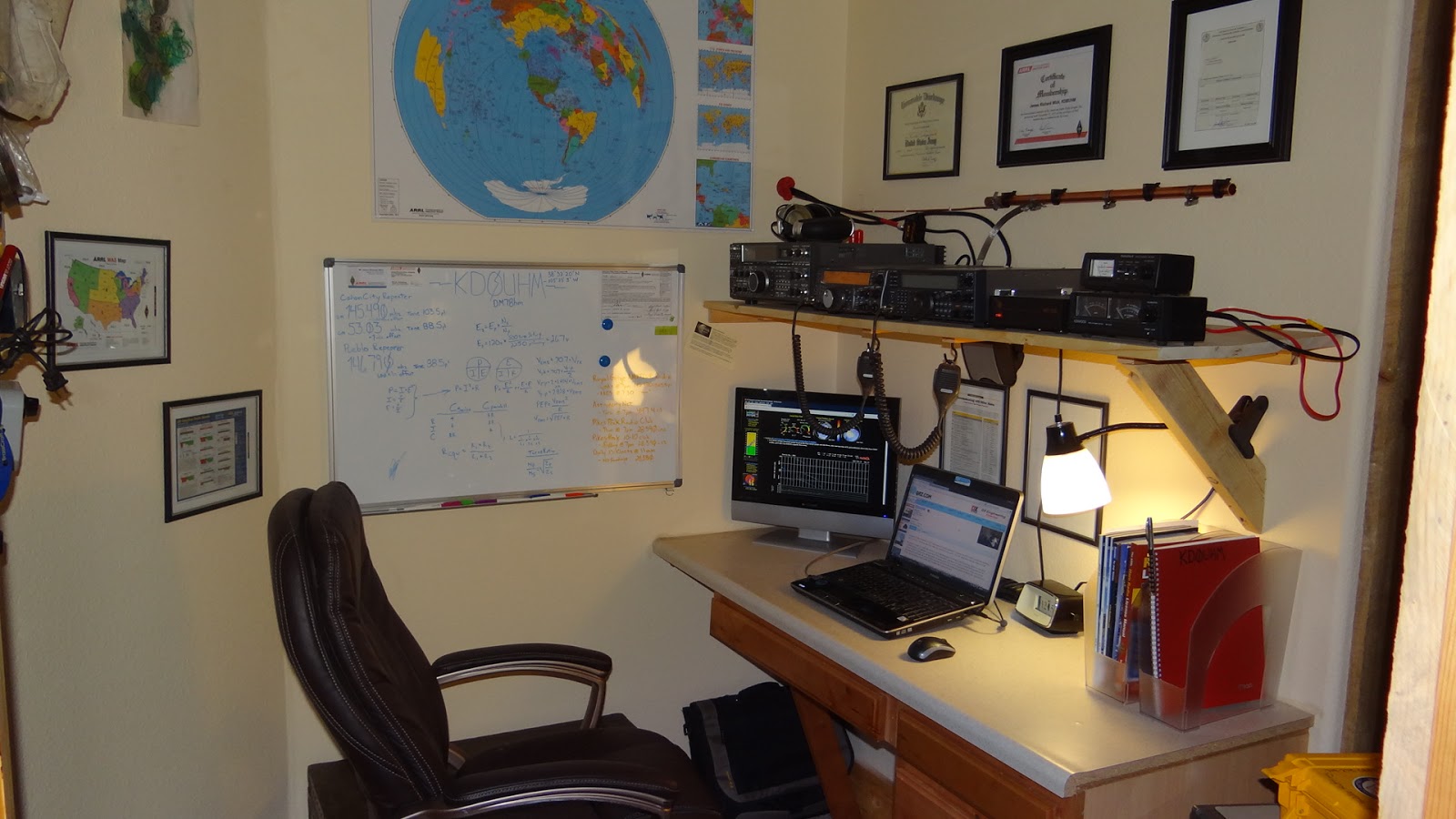 Another large desk is packed with lots of ham radio gear.
