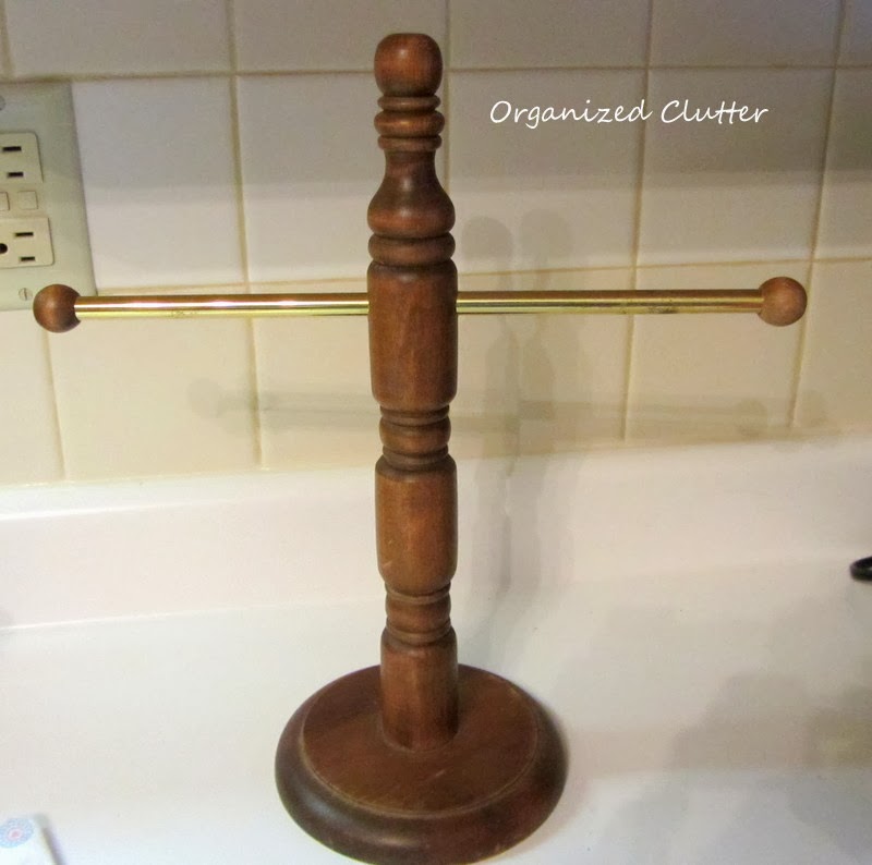 Just a countertop hand towel stand, made of wood with a metal bar ...