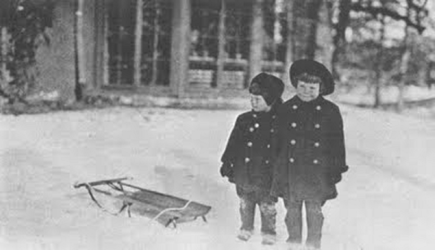 Katharine Hepburn and her big brother Tom  go sledding at their home in Hartford, CT.