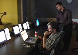 Photo of Santiago F.G. and Nick R. observe participants