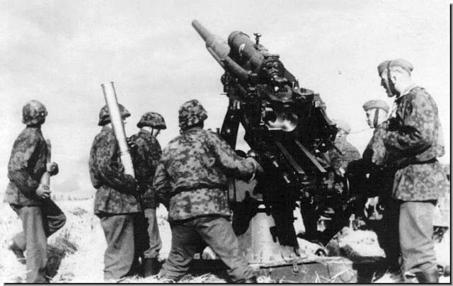 Waffen SS soldiers fire formidable German 88mm gun  tank-buster anti-aircraft gun.