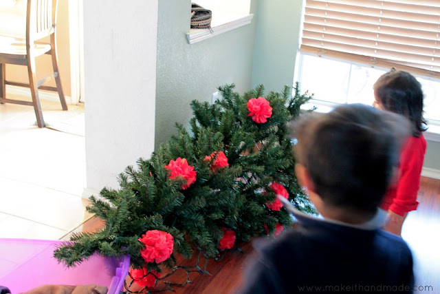 Easy Paper Pom Pom Ornament Tutorial by Make It Handmade. It only takes 2 dollars and 20 minutes to fill your tree with color!