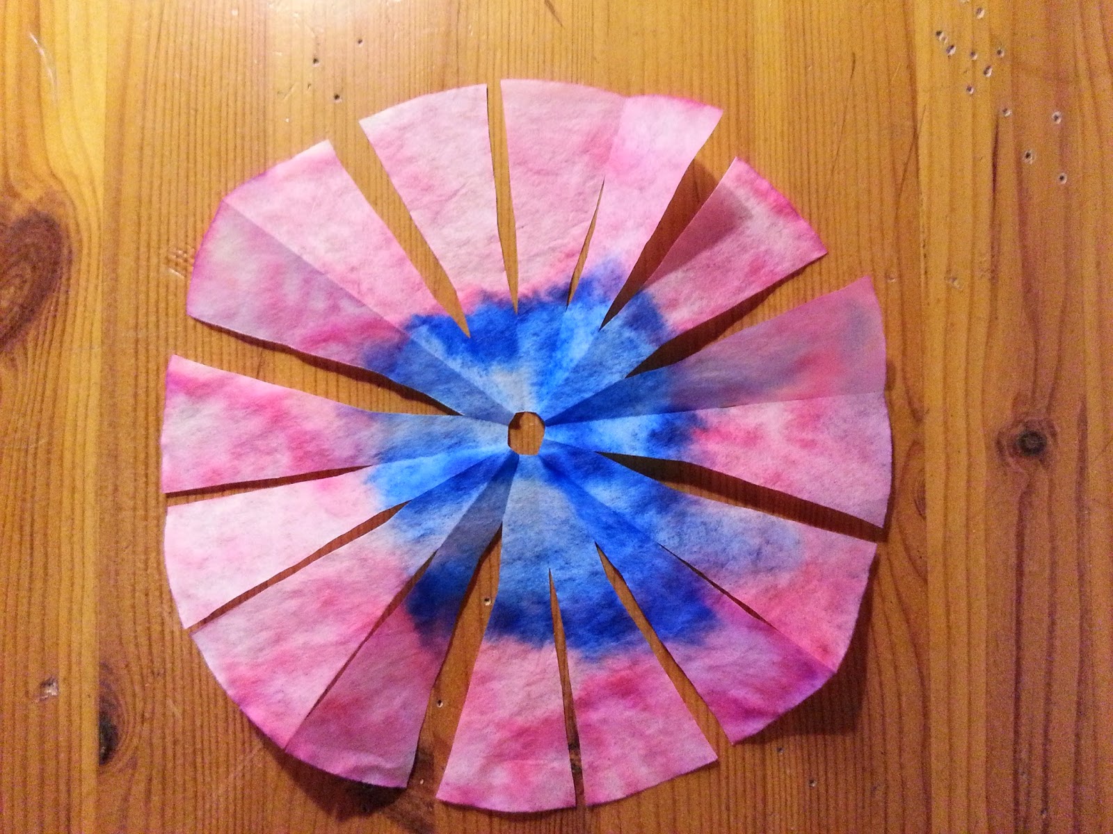 Place some tape on the back side of the flower. We used double sided.