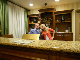 a man and woman standing behind a counter