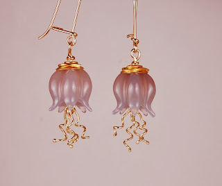 carved bluish grey moonstone pods with dangling 18k wires and 22k gold caps