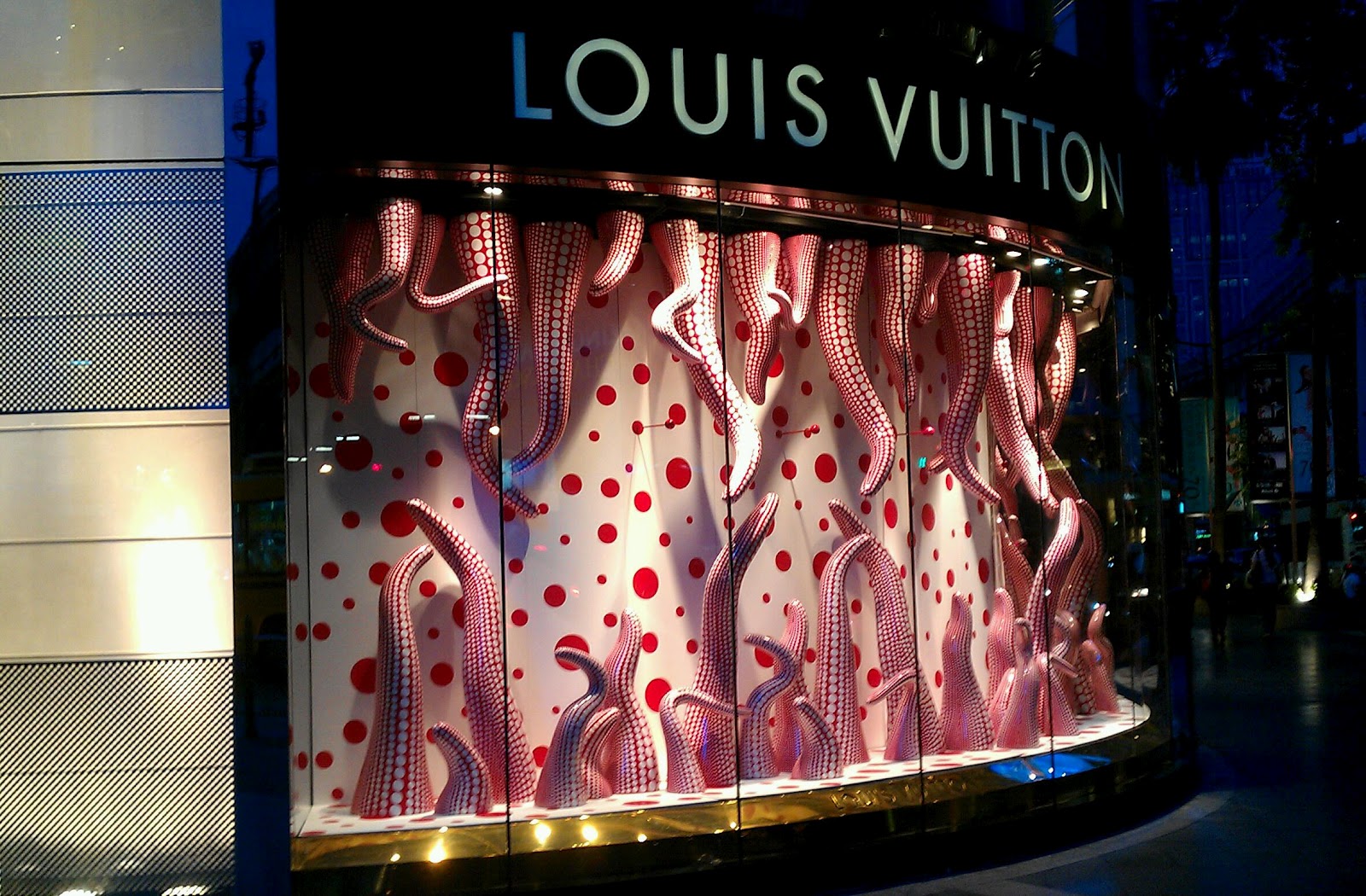 Louis Vuitton window is swarmed with golden bees dripping dazzling