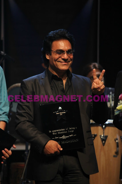 Singer Andy Madadian receives an award at Star Musician finale in Los Angeles