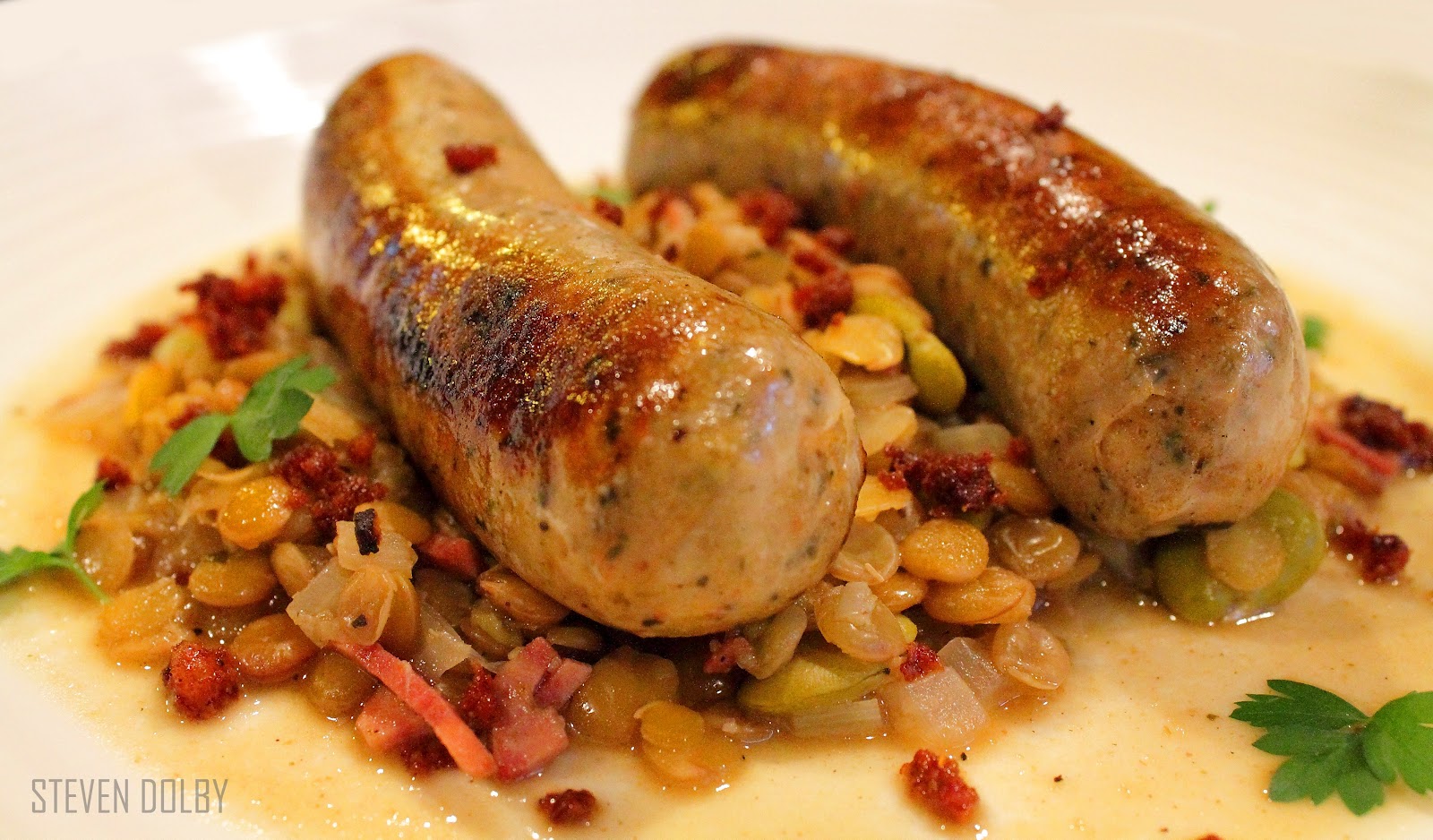 Italian sausages with braised lentils and crispy chorizo by Steven Dolby