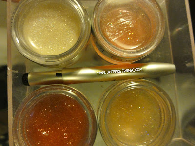 Red Earth lip glosses in little transparent jars