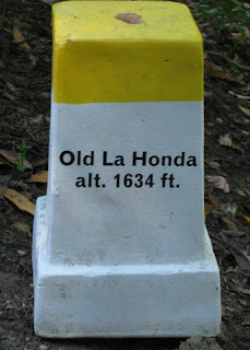 White road marker with a yellow top, Old La Honda, alt. 1634 ft, near Woodside, California