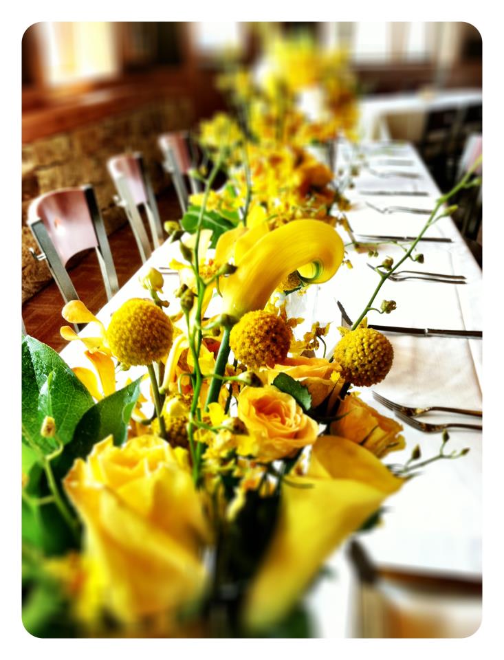 The table centerpieces were a tall pilsner vase filled with Oncidium Orchids
