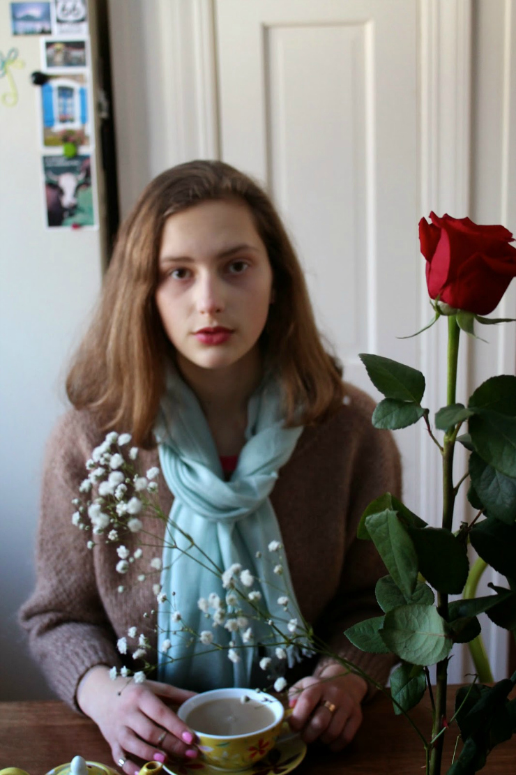 Caramel colored sweater, drinking tea with red lipstick