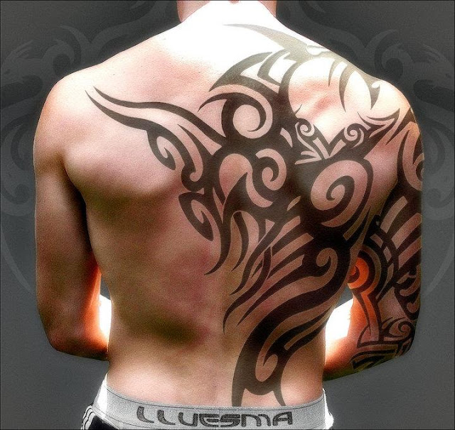 Tribal back tattoo on full back back body of a boy