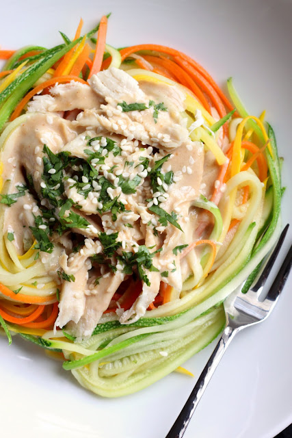 Close up of Zucchini Noodles with Chicken and Tangy Peanut Sauce in a white bowl