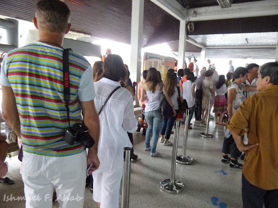 Tourists lining up for boats at Sathorn Pier, Chao Phraya River