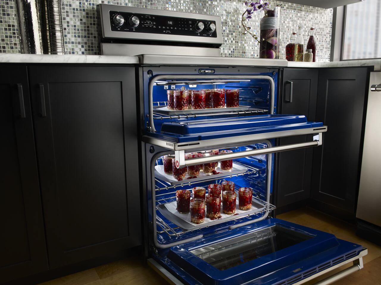 new kitchenaid induction double oven, oven doors open, blue interior oven