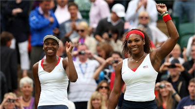 Serena Williams (R) and Venus Williams (L) of the United States celebrates victory