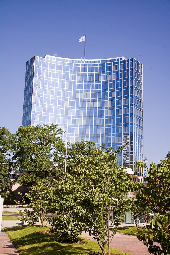 A tall modern building flying a UN flag