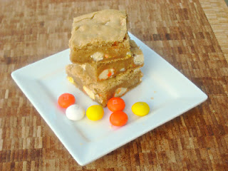 blondies stacked on a white plate with M&ms next to them
