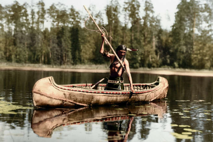 1908, Ojibwe Native spear fishing in Minnesota.