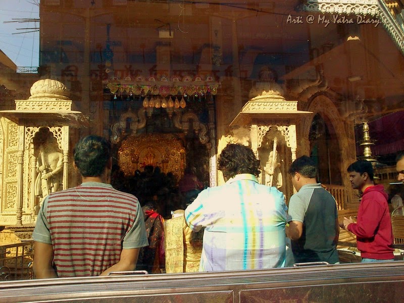Prayers to Shreemant Dagduseth Halwai Ganpati Temple through the window, Pune - India