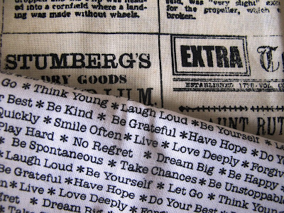 Two pieces of black and white fabric printed with words.